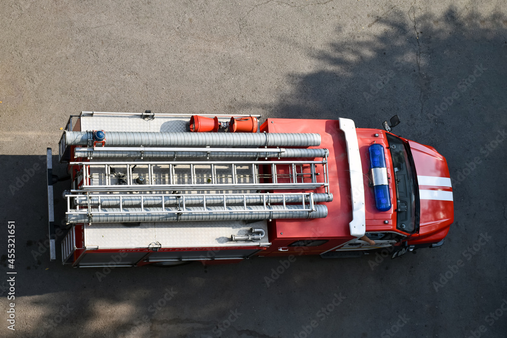 Fire truck, top view from the window of a house or building. View from above