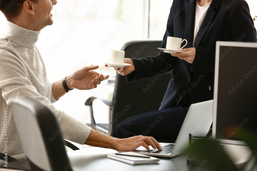 Business colleagues drinking coffee in office