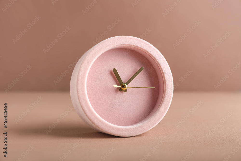 Stylish alarm clock on color background