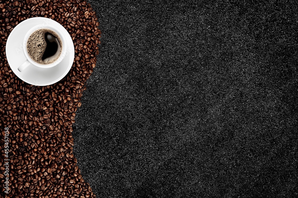 Black hot coffee with foam in a white ceramic cup with coffee beans