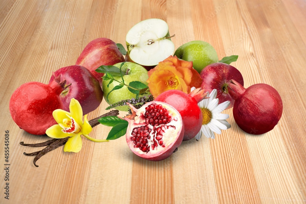 Pomegranates and red apples on the desk, traditional food of Jewish New Year