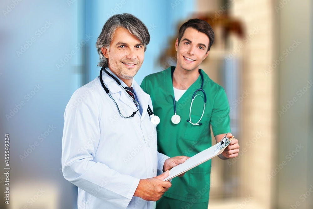 Handsome doctor In medical Unifrom with a clipboard in hospital