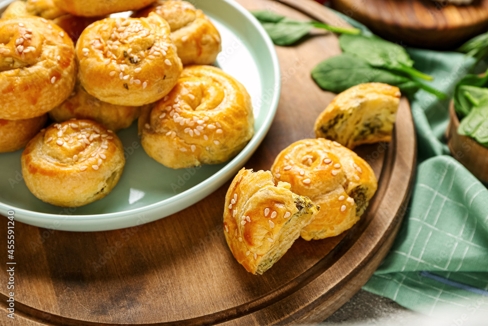 Puff pastry stuffed with spinach on board