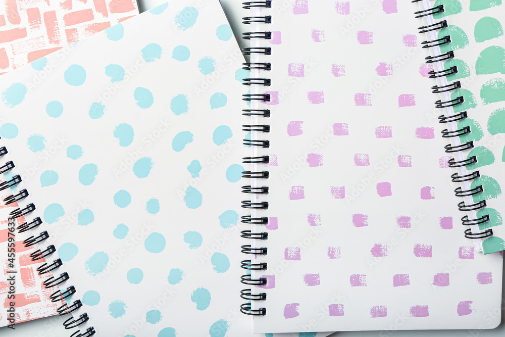 Stylish notebooks as background, closeup