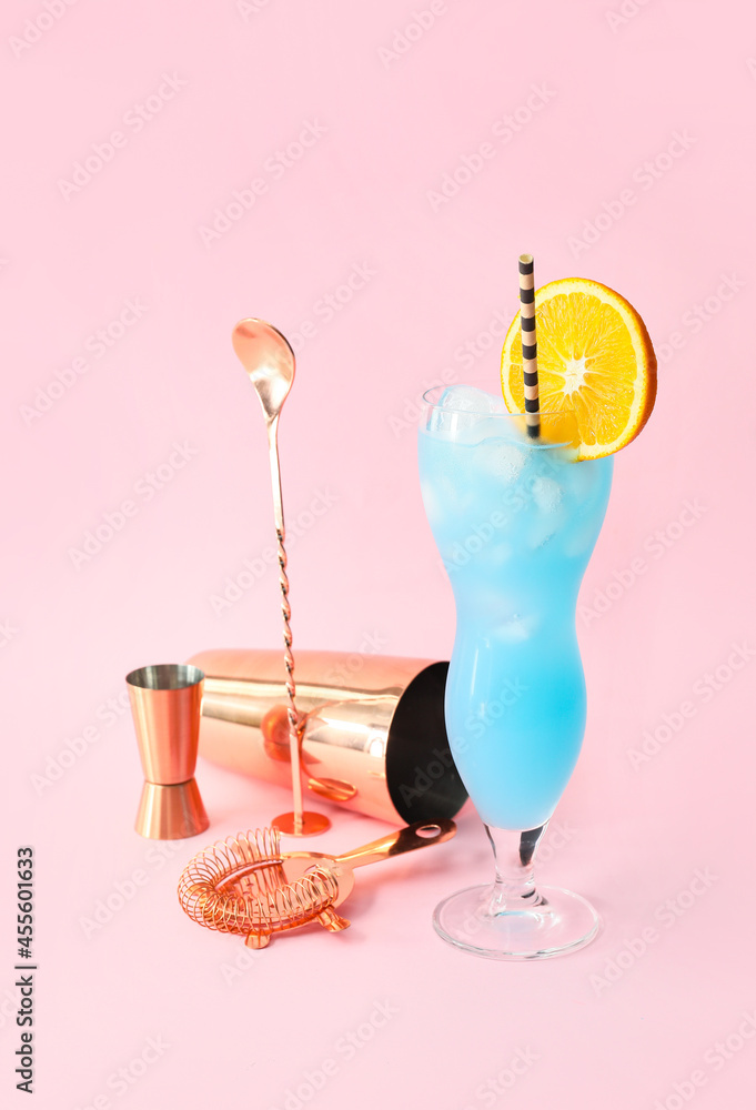 Glass of Blue Lagoon cocktail on color background