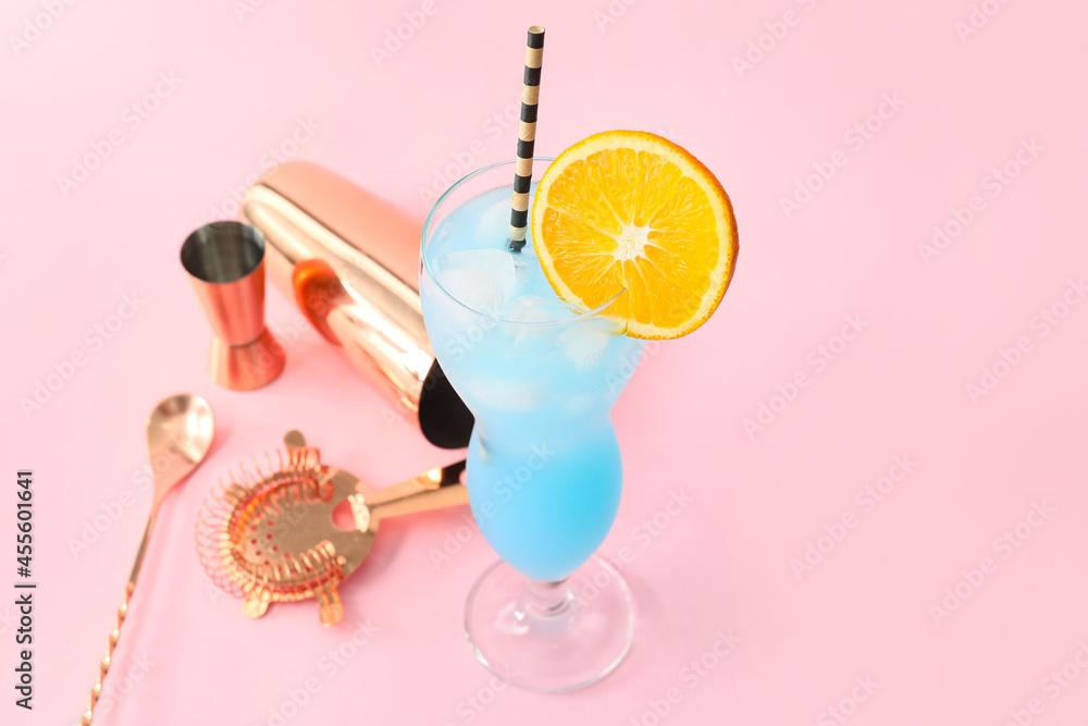 Glass of Blue Lagoon cocktail on color background