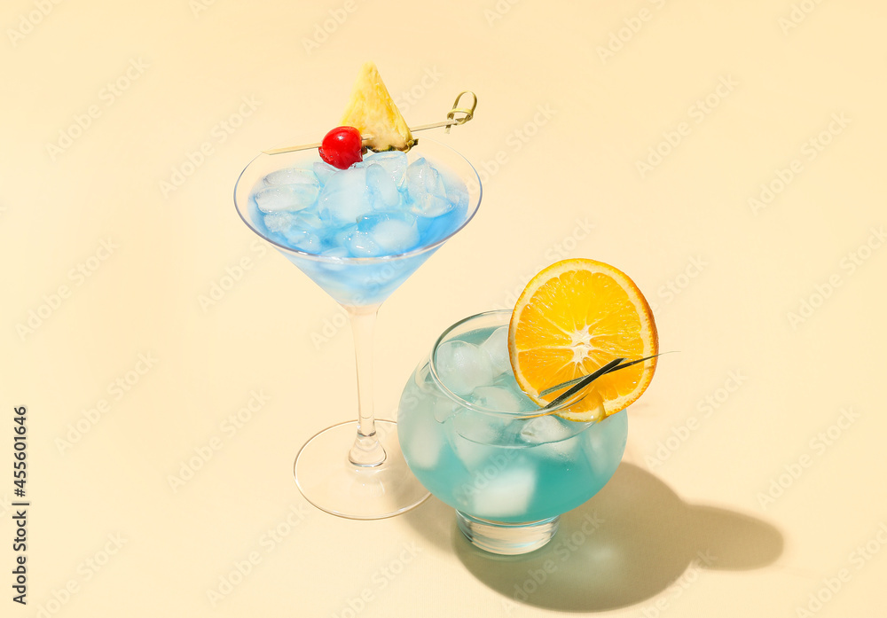 Glasses of Blue Lagoon cocktail on color background