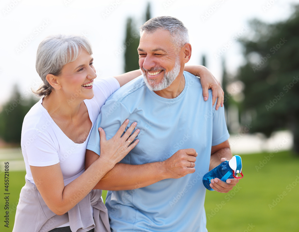 Portrait of lovely happy elderly couple on morning run outside in city park