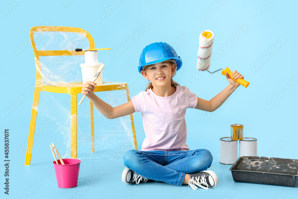 Little painter with brush and roller on color background