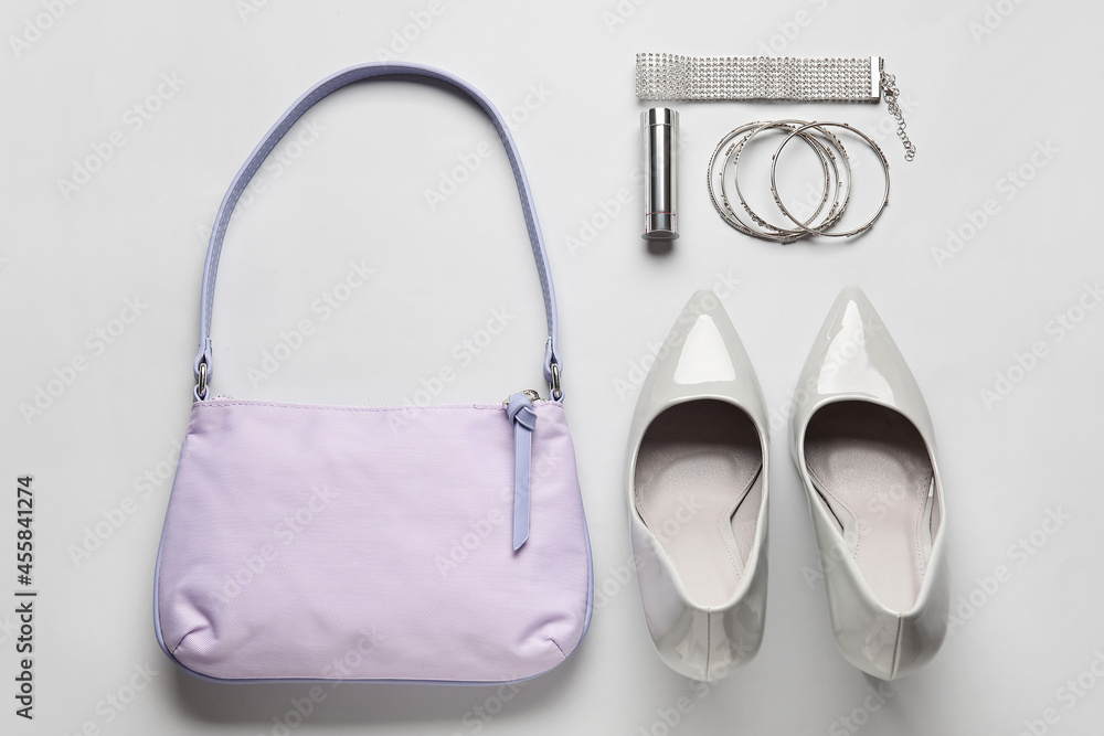 Composition with stylish handbag and accessories on light background