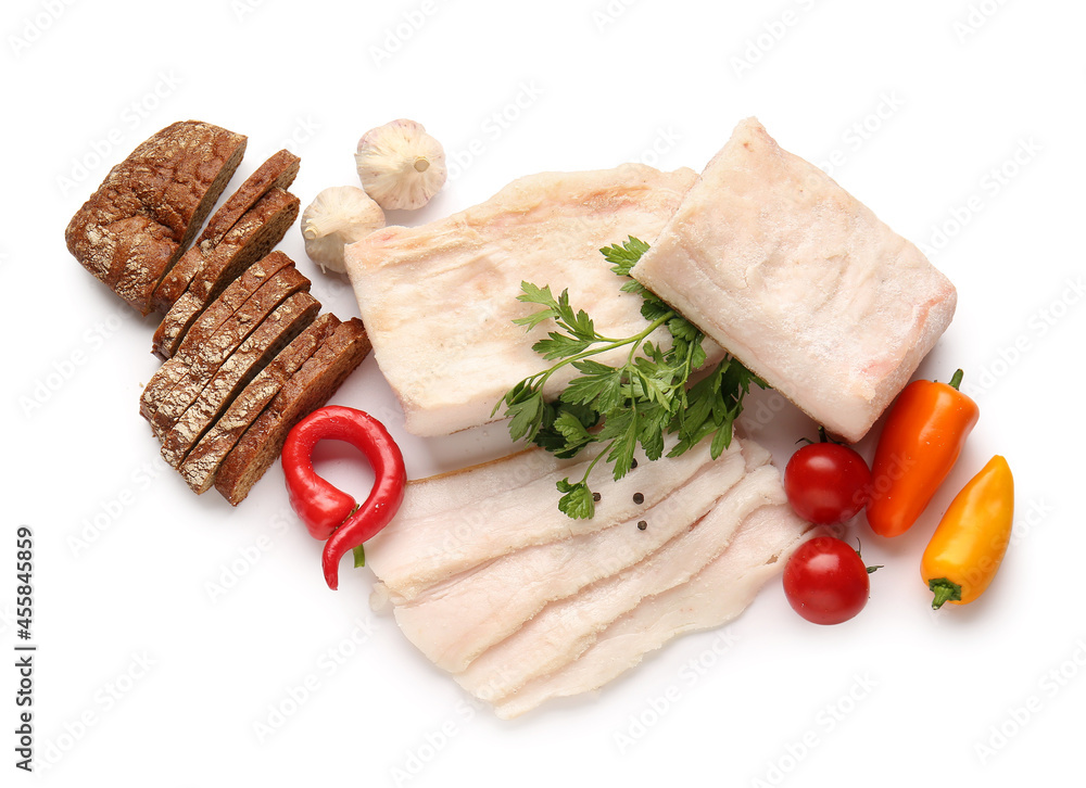 Salted lard with fresh vegetables and bread on white background