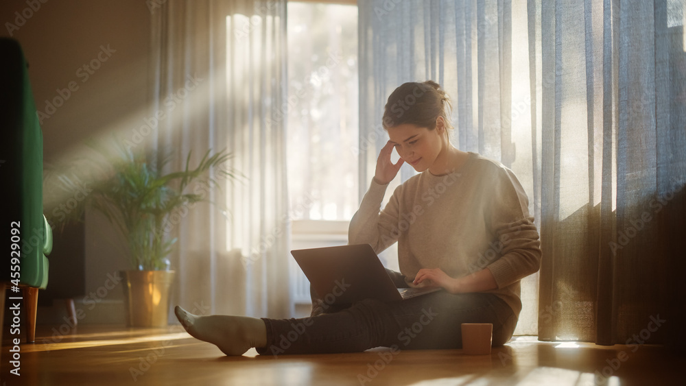 Beautiful Happy Woman Using Laptop at Home for Remote Work. Young Adult Smiling Woman Sitting on the