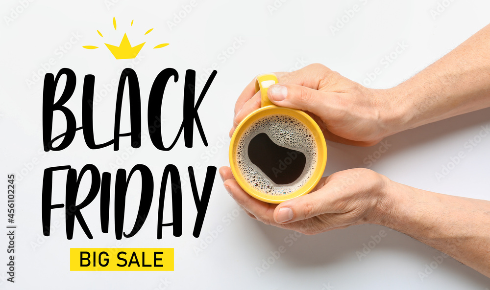 Male hands with cup of coffee and text BLACK FRIDAY BIG SALE on white background