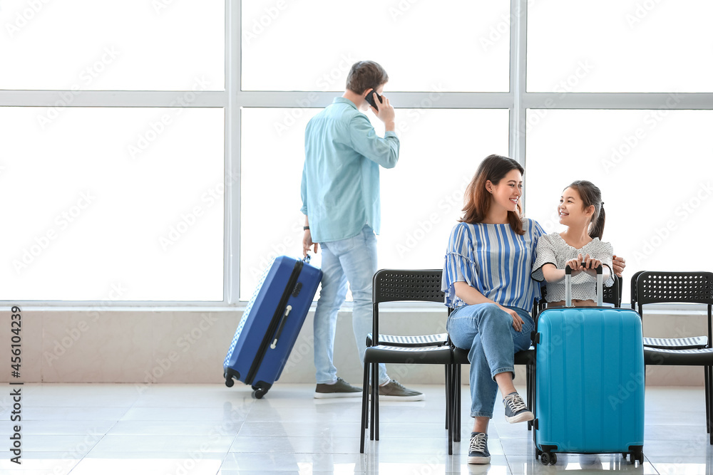 Family waiting for their flight at the airport