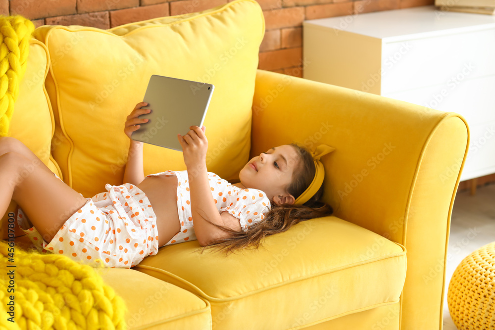 Cute girl watching cartoons at home