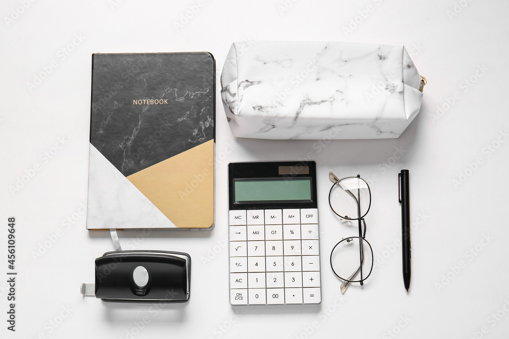 Pencil case, eyeglasses and stationery on white background