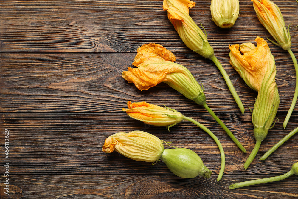 Flowers of zucchini on wooden background