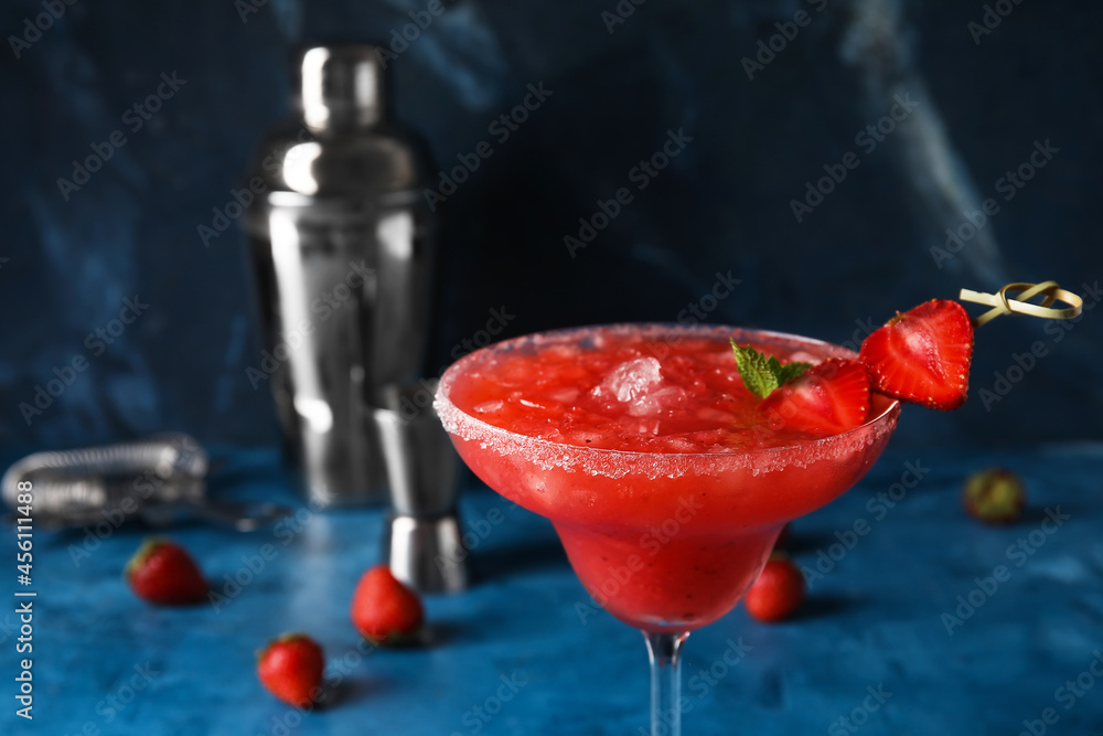 Glass of tasty strawberry margarita on color background, closeup