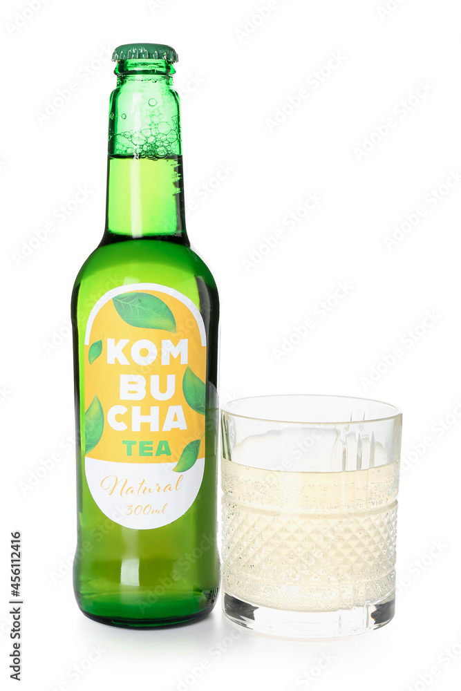 Glass and bottle of natural kombucha tea on white background