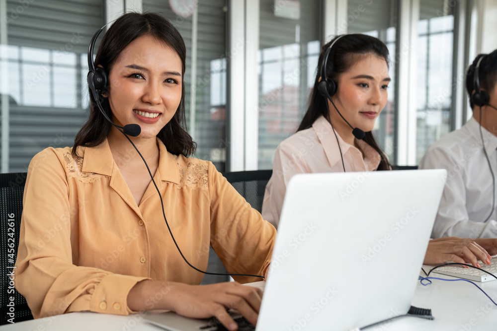 Business people wearing headset working actively in office . Call center, telemarketing, customer su