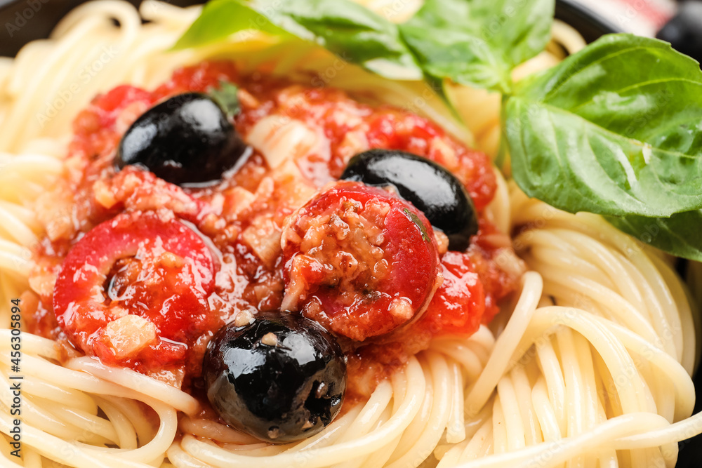 Tasty Pasta Puttanesca on plate, closeup