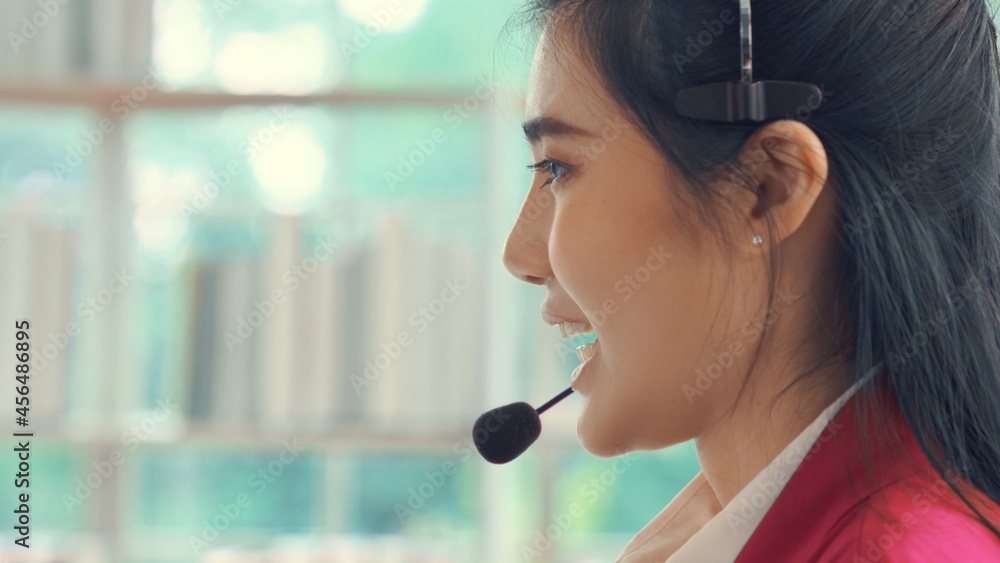 Businesswoman wearing headset working actively in office . Call center, telemarketing, customer supp