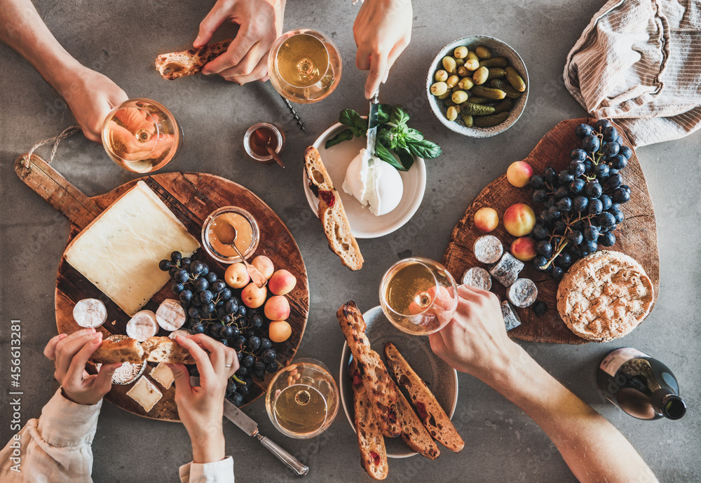 Flat-lay of people drinking wine eating gourmet snacks