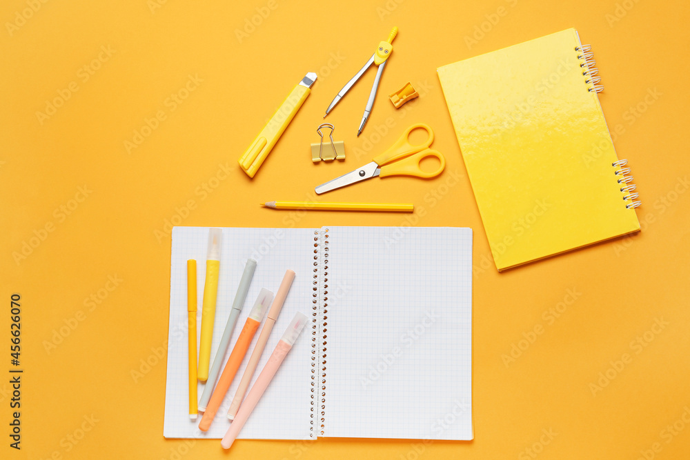 Stationery supplies and blank notebook on color background