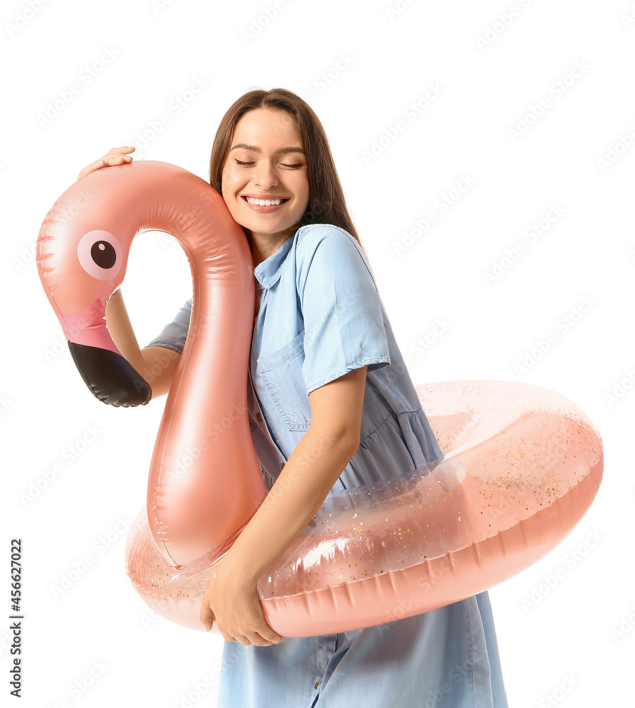 Young woman with inflatable ring on white background