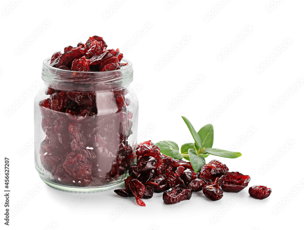 Glass jar with tasty dried cranberries on white background