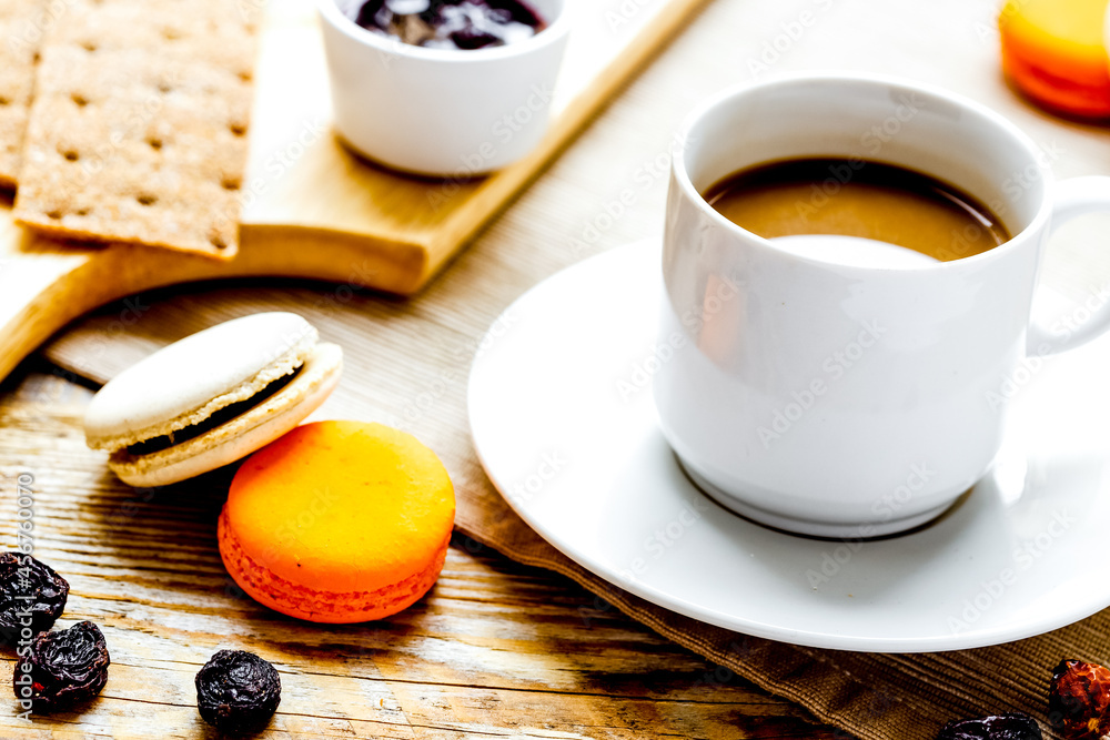 Breakfast with coffee, crackers and croissants on wooden table