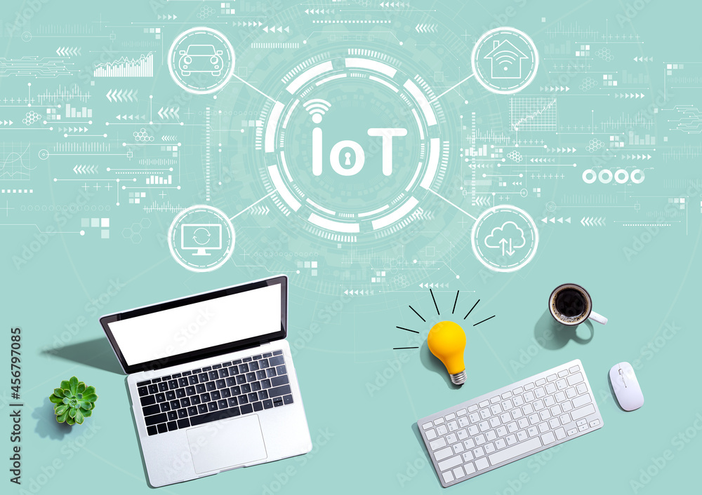 IoT theme with computers with a light bulb from above