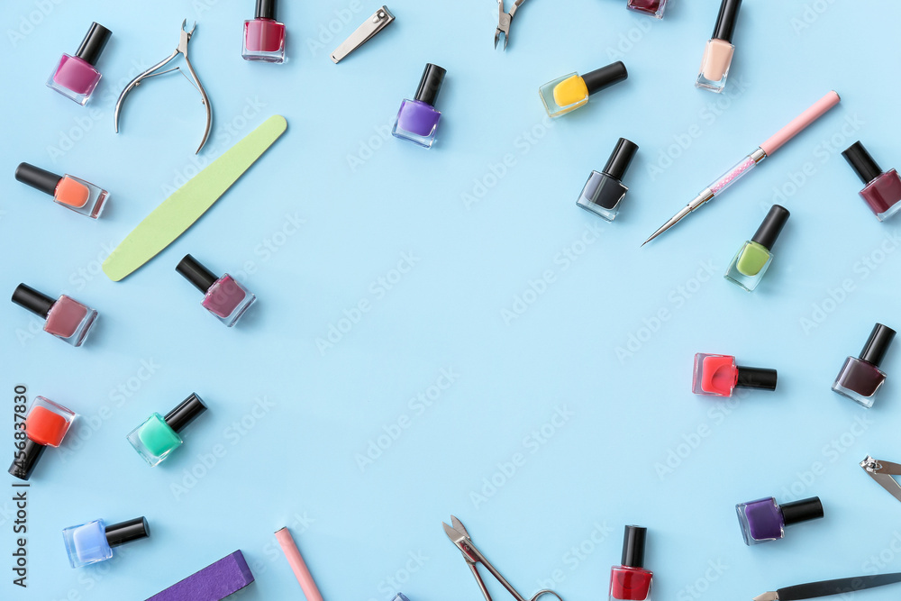 Frame made of tools for manicure and nail polishes on color background