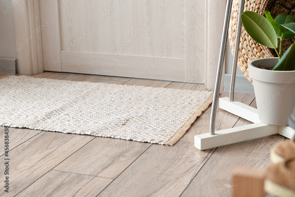 Stylish rug on floor in interior of modern hallway