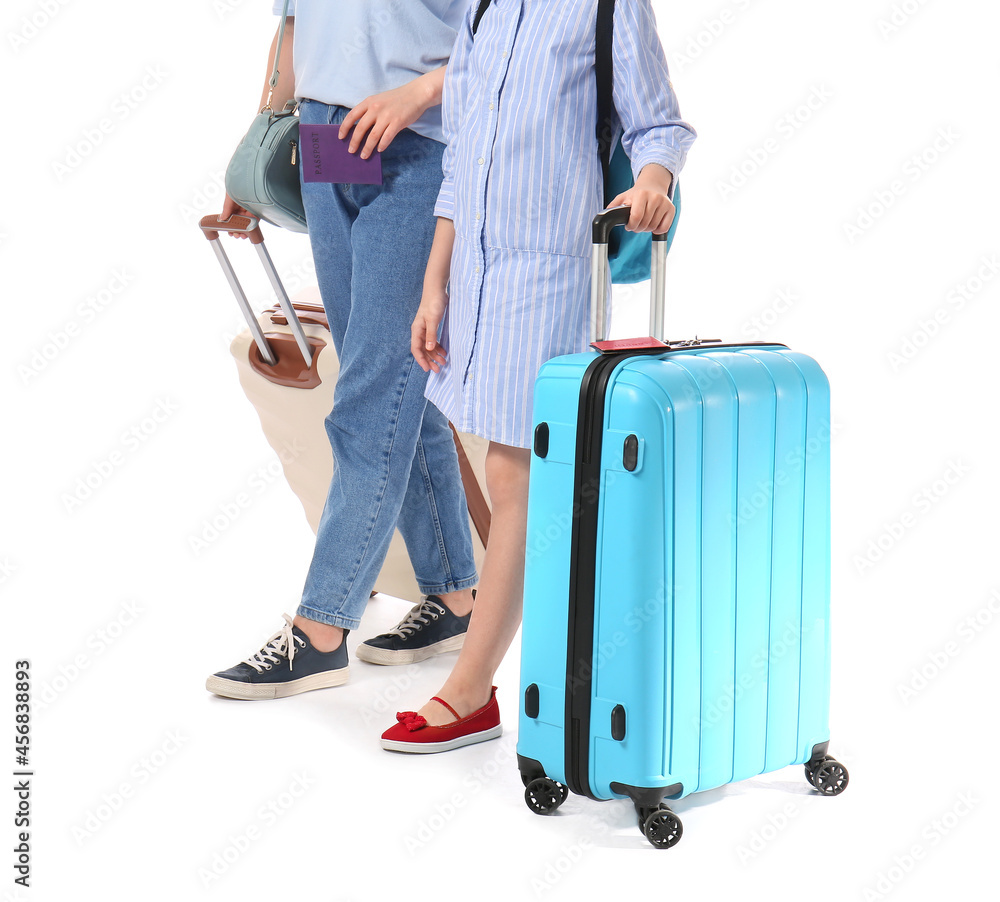 Mother and daughter with luggage on white background. Concept of tourism