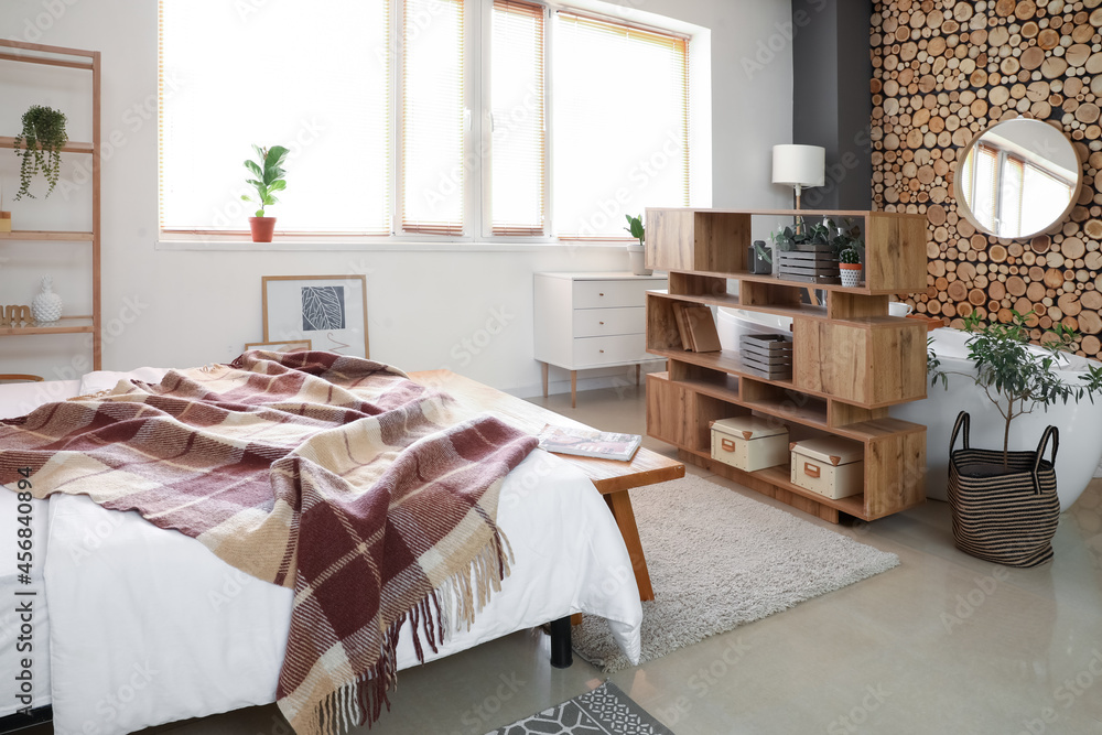 Interior of stylish bedroom with book shelf