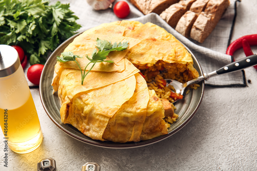 Plate with tasty Shah Pilaf on light background