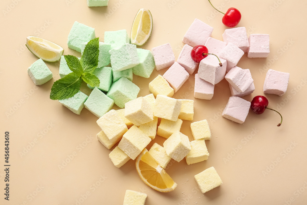 Tasty sweet marshmallows, fruits and mint on color background