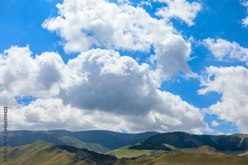 Blue sky and white clouds on top of the mountain.