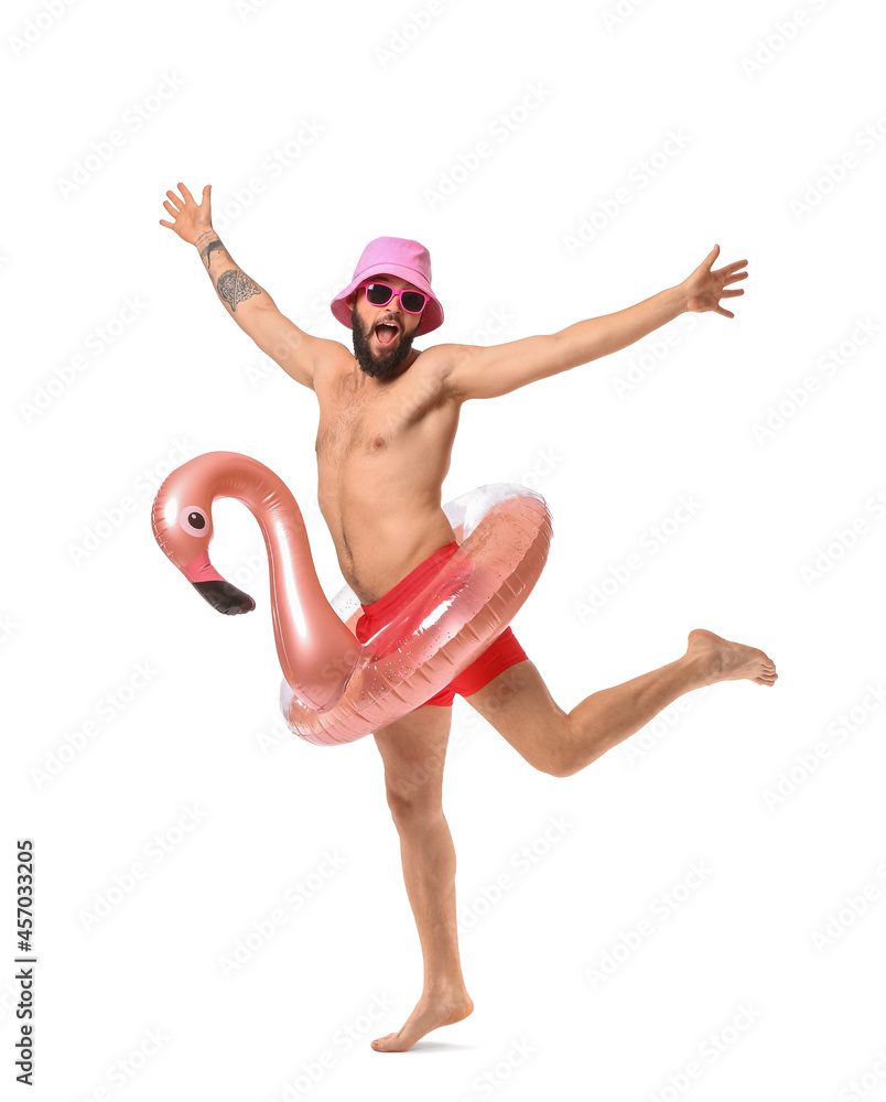 Funny young man with inflatable ring on white background