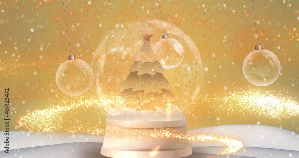 Digital image of snow falling over shooting star spinning around christmas tree in snow globe an