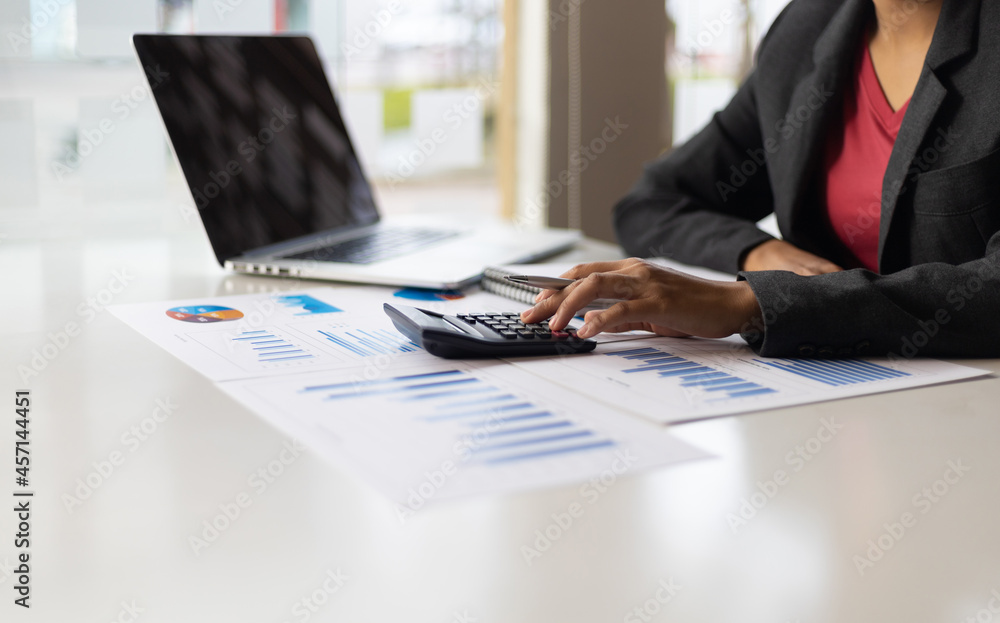 Business woman calculates accounting and analyzes finances.