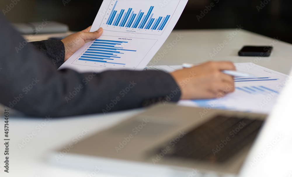 Business man holding business report paperwork and business data analysis.