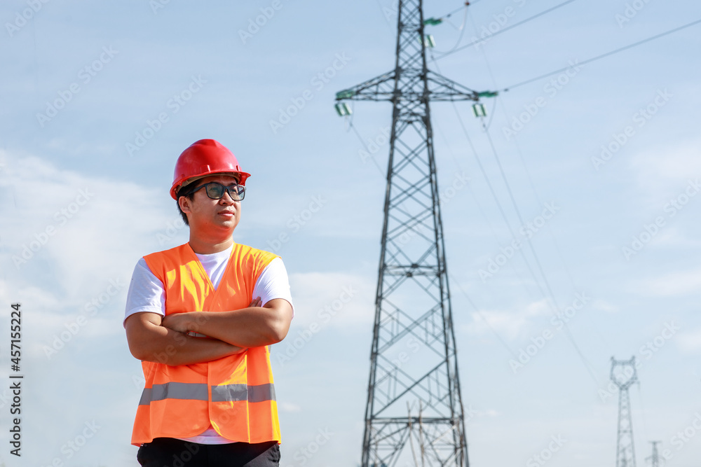 Asian electrical engineers worker in standard safety uniform standing at a power station to working 