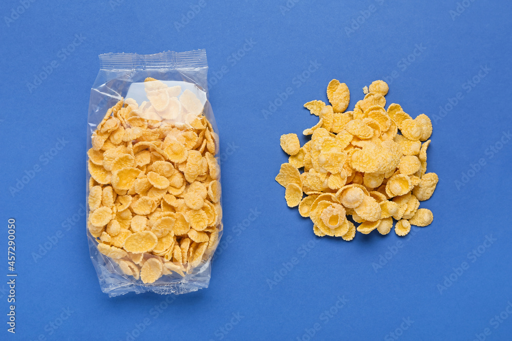 Bag of tasty cornflakes on color background