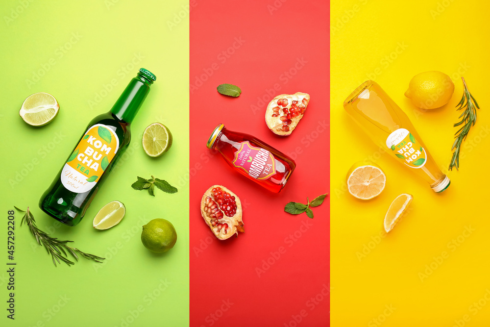 Composition with bottles of different kombucha tea on color background