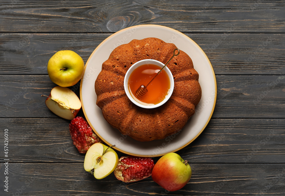 Bread with honey, pomegranate and apples on dark wooden background. Rosh hashanah (Jewish New Year) 