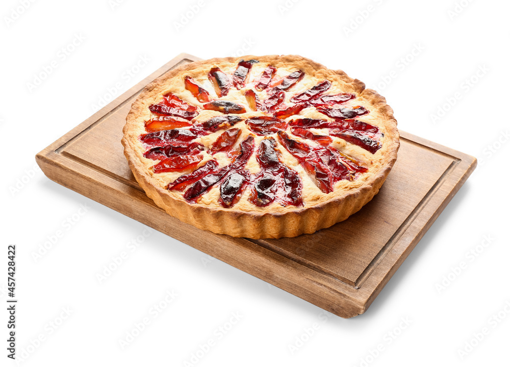 Board with tasty plum pie on white background