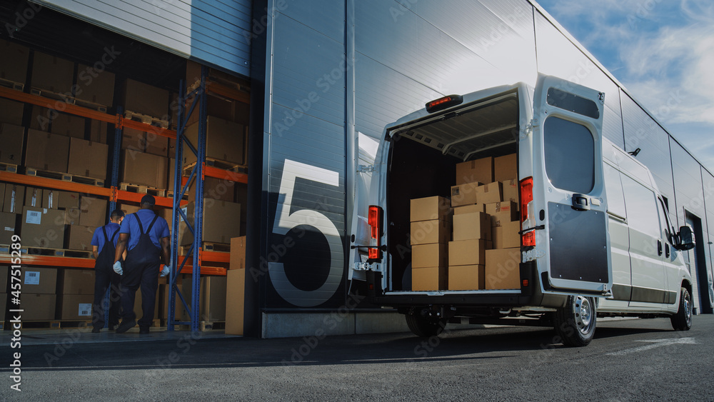 Outside of Logistics Distributions Warehouse: Two Workers Load Delivery Truck with Cardboard Boxes, 