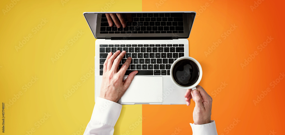 Businessman using a laptop computer overhead view